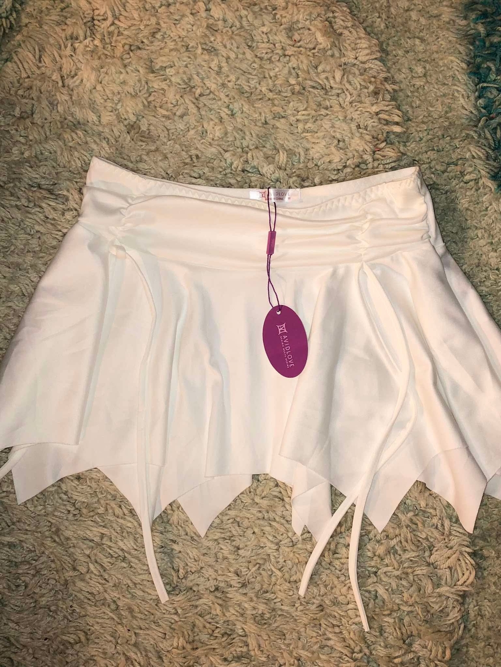 Avidlove white mini skirt features an irregular hem and drawstring details